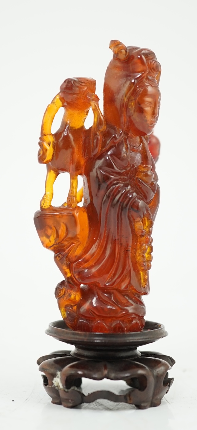 A Chinese amber group of Guanyin, 19th century, small losses